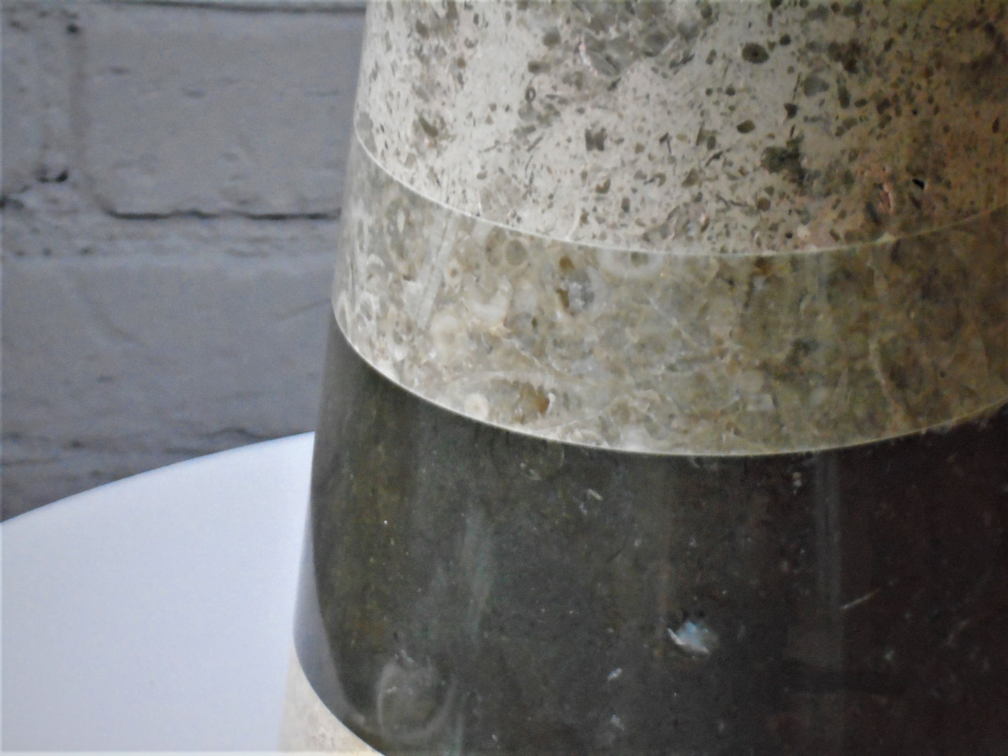 A conical Lamp Base turned from a selection of English Stones