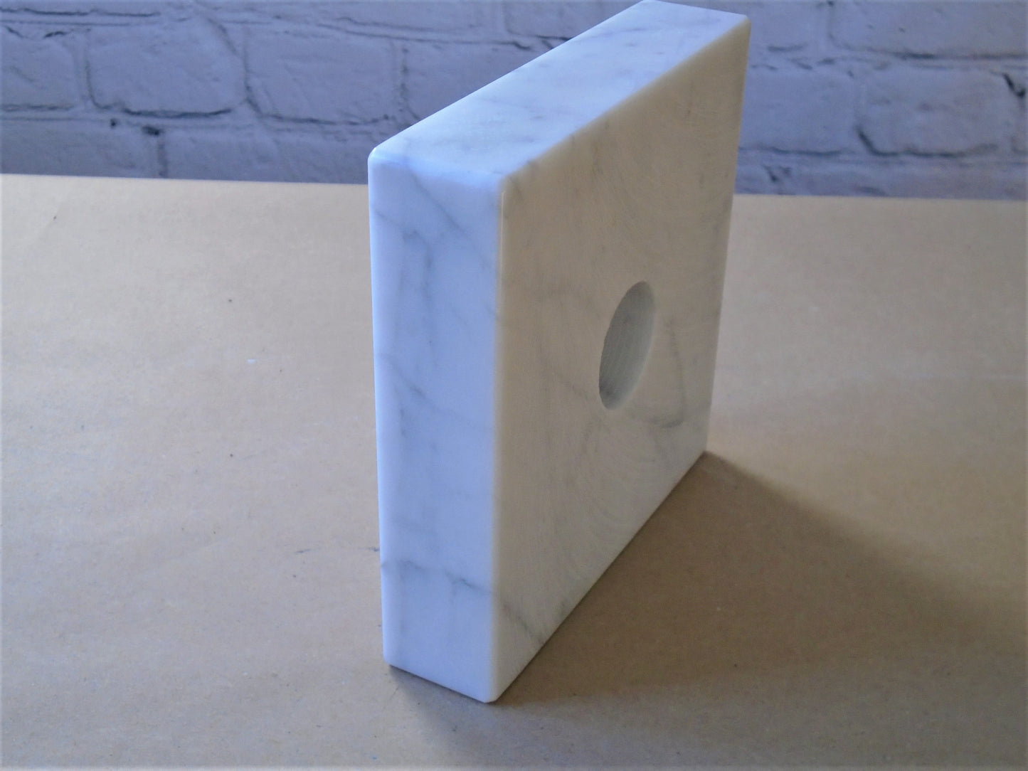A Carrara Marble Base.
