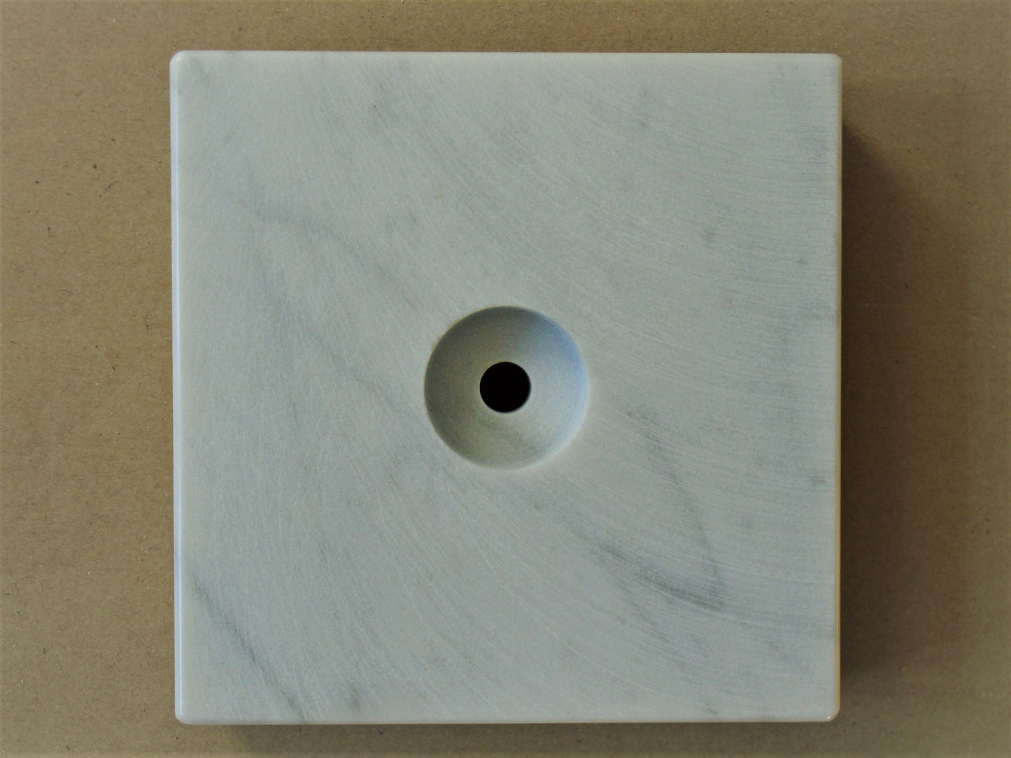 A Carrara Marble Base.