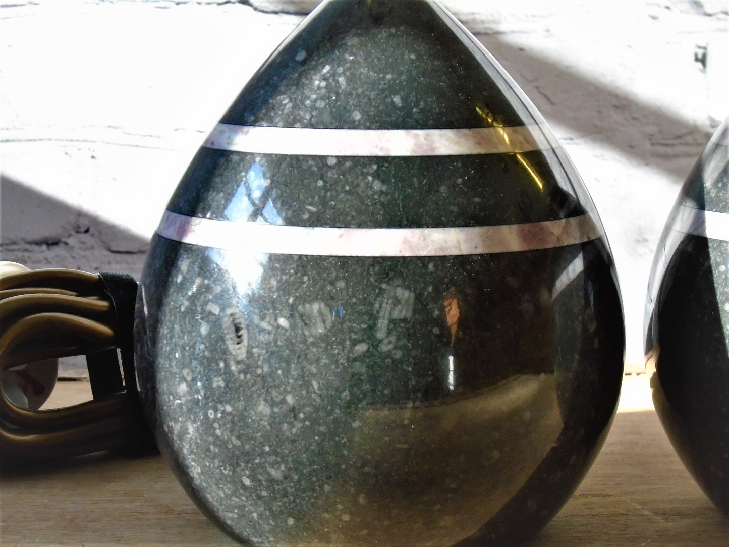 A Pair of Table/Bedside Lamps turned from Kilkenny Fossil with Fleur de Peche Bands