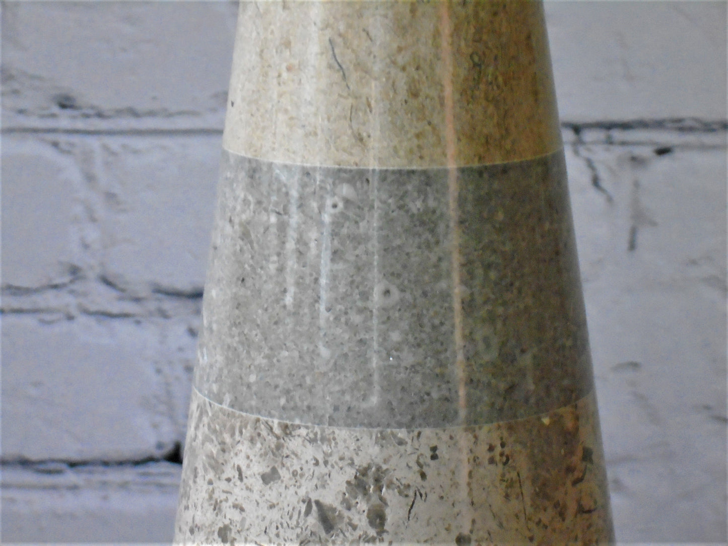 A conical Lamp Base turned from a selection of English Stones